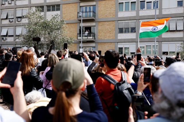 Faithful gather, as Pope Francis is discharged from Gemelli Hospital, in Rome, Italy, on March 23, 2025.