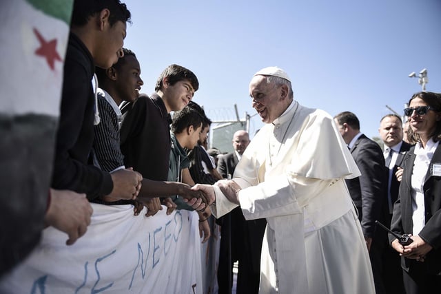 In this handout image provided by Greek Prime Minister's Office, Pope Francis meets migrants at the Moria detention center on April 16, 2016 in Mytilene, Lesbos, Greece.