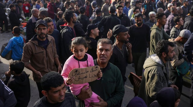 A child carries a sign reading in Arabic: "The children of Palestine: We want to live", during a rally calling for an end to the war, in Beit Lahia, in the northern Gaza Strip, on March 25, 2025. Hundreds of Palestinians chanted anti-Hamas slogans at a protest in northern Gaza on March 25, calling for an end to the war with Israel, witnesses said. (AFP via Getty Images)