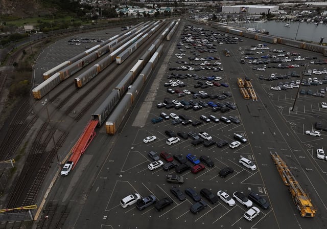 In an aerial view, brand new cars are taken off of train cars at a rail yard on March 04, 2025 in Richmond, California. U.S. tariffs against Mexico, China and Canada went into effect on March 4th and could be as high as 25 percent on all imports.