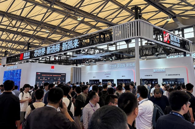 Visitors walk past the SiCarrier booth during SEMICON China, a trade fair for the semiconductor industry, in Shanghai, China March 26, 2025. REUTERS/Che Pan