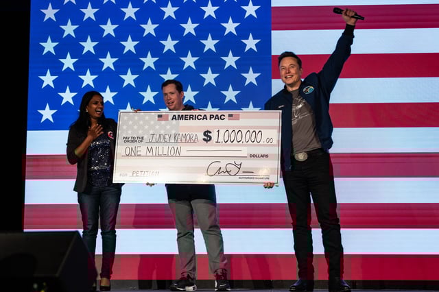SpaceX and Tesla founder Elon Musk awards Judey Kamora with $1,000,000 during an America PAC town hall on October 26, 2024 in Lancaster, Pennsylvania.
