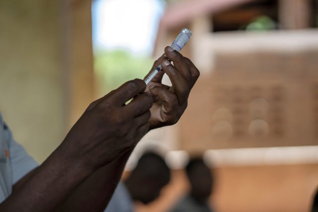 FILE - Health officials prepare to administer a vaccine in the Malawi village of Tomali with the world's first vaccine against malaria in a pilot program in Tomali, Dec. 11, 2019. (AP Photo/Jerome Delay, File)