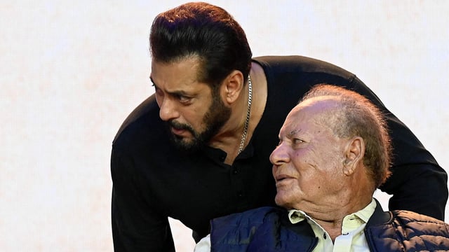 Bollywood actor Salman Khan (top R) with his father, film producer and screenwriter Salim Khan (seated R). 