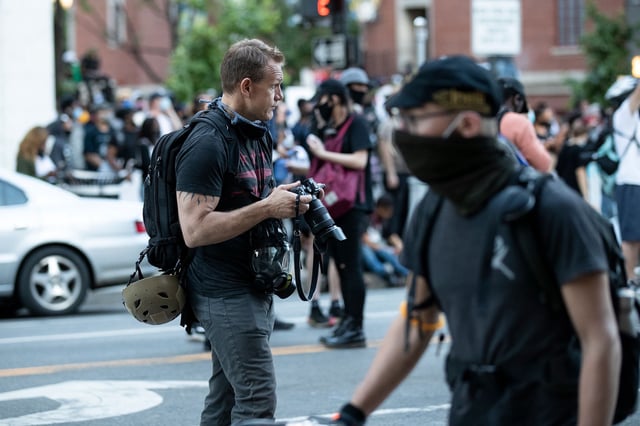 In this May 2020 photo, Associated Press photographer Evan Vucci covers demonstrators as they gather to protest the death of George Floyd near the White House in Washington, DC.