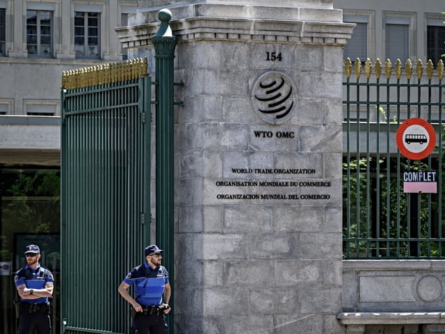 Police officers guard the entrance of the headquarters of the World Trade Organization on the eve of the WTO Ministerial Conference in Geneva on June 11, 2022. (Photo by Fabrice COFFRINI / AFP) (Photo by FABRICE COFFRINI/AFP via Getty Images)
