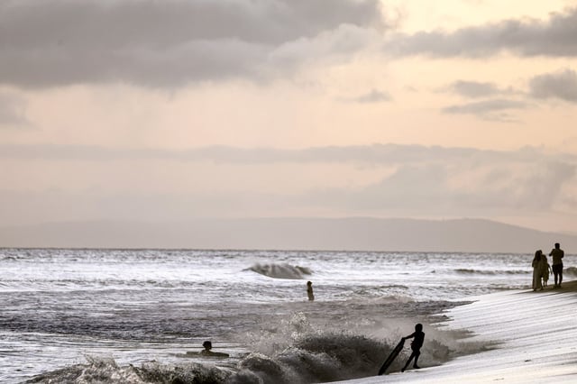 People gather on the beach on Aug. 4, 2024 in Lahaina, Hawaii.