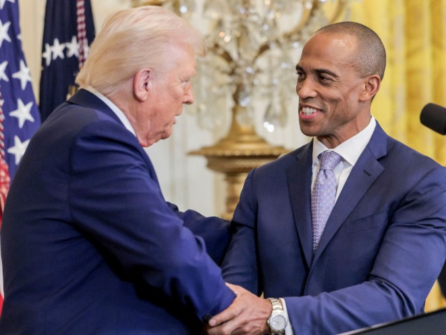US President Donald Trump, left, and Eric Scott Turner, US secretary of Housing and Urban Development (HUD), shake hands in the East Room of the White House in Washington, DC, US, on Thursday, Feb. 20, 2025. The reception, which was held in honor of Black History Month, comes as Trump has ordered his administration to push companies to scrap diversity, equity, and inclusion (DEI) programs. Photographer: Shawn Thew/EPA/Bloomberg