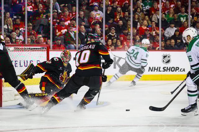 Mar 27, 2025; Calgary, Alberta, CAN; Dallas Stars right wing Mikko Rantanen (96) scores a goal against Calgary Flames goaltender Dustin Wolf (32) during the third period at Scotiabank Saddledome. Mandatory Credit: Sergei Belski-Imagn Images