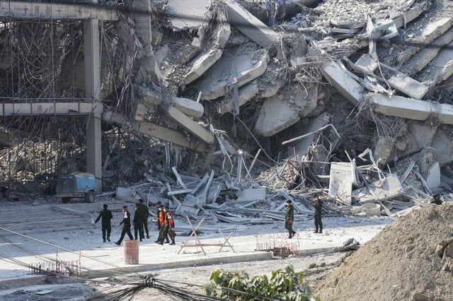 Rescuers walk at the site of a high-rise building under construction that collapsed after a 7.7 magnitude earthquake in Bangkok, Thailand, Friday, March 28, 2025. (AP Photo/Sakchai Lalit)