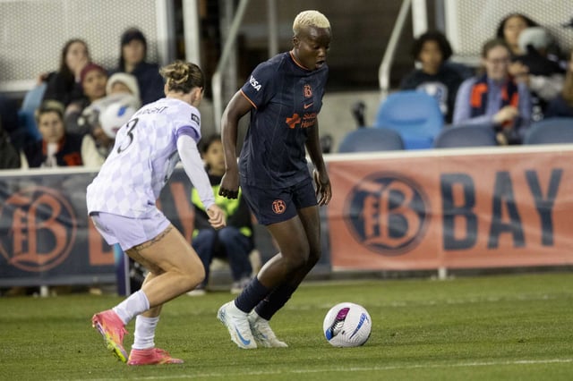 Bay FC forward Racheal Kundananji, right, drives the ball as Racing Louisville’s Arin Wright defends during the second half of an NWSL match in San Jose on Saturday.