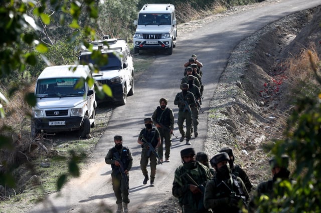 Indian security force personnel patrol near the site of a gun battle with suspected militants in a forest area in Kathua district of Jammu and Kashmir, March 28, 2025. REUTERS/Stringer
