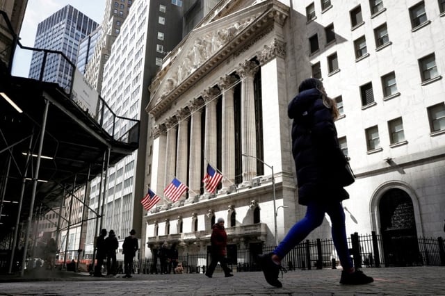 People are seen on Wall Street outside the New York Stock Exchange (NYSE) in New York City, U.S., March 19, 2021.  REUTERS/Brendan McDermid/File Photo