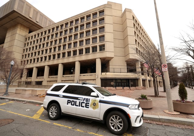 An FBI police car stands outside FBI headquarters in Washington, U.S., February 3, 2025. REUTERS/Kevin Lamarque/File Photo