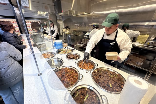 A Jagalchi employee packages hot food for a customer in Daly City, on Friday, March 28, 2025. 