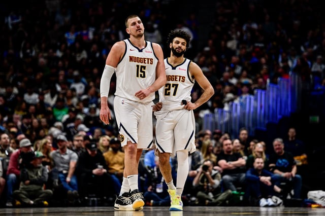 Nikola Jokic #15 and Jamal Murray #27 of the Denver Nuggets look on in the second half against the Washington Wizards at Ball Arena on March 15, 2025 in Denver, Colorado.