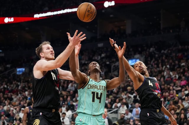 Toronto Raptors centre Jakob Poeltl (19) and forward Scottie Barnes (4) compete for a rebound against Charlotte Hornets forward Moussa Diabate (14) during first half NBA basketball action in Toronto on Friday, March 28, 2025. THE CANADIAN PRESS/Arlyn McAdorey