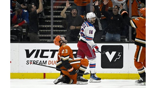 Ducks center Mason McTavish, left, celebrates after scoring the game-winning overtime goal as New York Rangers center Vincent Trocheck skates by on Friday night at the Honda Center. The Ducks won, 5-4. (AP Photo/Alex Gallardo)