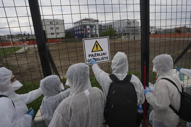 Protesting students stage a symbolic "decontamination" outside a key pro-government television station, The Informer TV accusing it of spreading hate speech during nearly five months of persistent street demonstrations against corruption in Belgrade, Serbia, Saturday, March 29, 2025. (AP Photo/Darko Vojinovic)