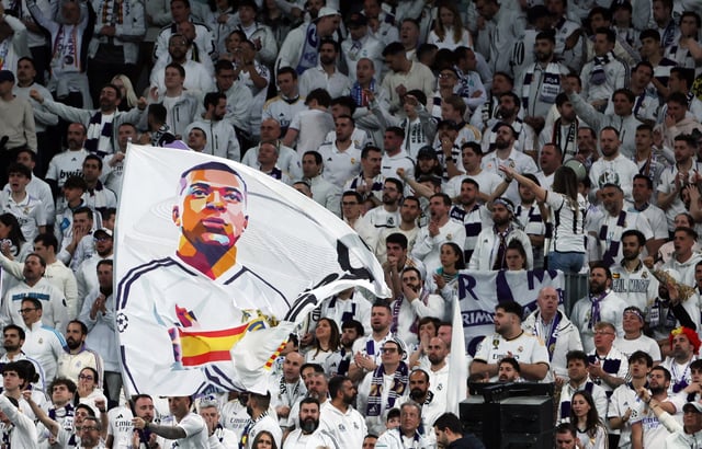 Soccer Football - LaLiga - Real Madrid v Leganes - Santiago Bernabeu, Madrid, Spain - March 29, 2025 Real Madrid fans display a flag showing Kylian Mbappe in the stands REUTERS/Isabel Infantes