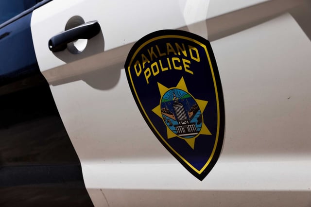 An Oakland officer was injured when a pedestrian punched him through the window of a patrol car Friday, police said. 