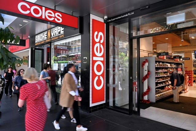 People walk past a Coles supermarket in Melbourne's central business in 2024.