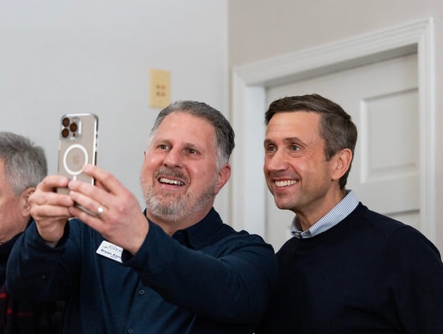 (Left) Glendale Mayor Bryan Kennedy takes a selfie with (right) Democratic National Committee Chair Ken Martin at a canvassing event on Saturday February 22, 2025 in Glendale, Wis.