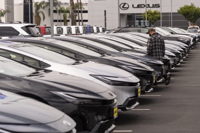 A person looks at a new vehicle at a Toyota dealership in El Monte, Calif., Thursday, March 27, 2025. (AP Photo/Jae C. Hong)