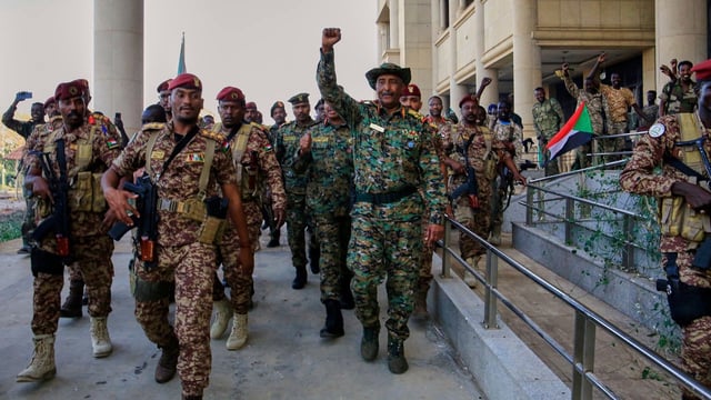 Sudan's military chief Gen. Abdel-Fattah Burhan greeted by troops as he arrives at the Republican Palace, recently recaptured from the Rapid Support Forces paramilitary group, in Khartoum, Sudan.