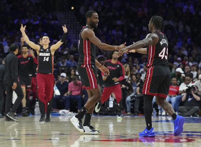 Heat forward Alec Burks (left) celebrates with teammate Davion Mitchell against the Philadelphia 76ers during the second half at the Wells Fargo Center on March 29, 2025 in Philadelphia, Pennsylvania. (Mitchell Leff/Getty Images)