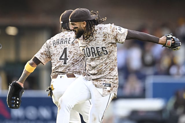Mar 30, 2025; San Diego, California, USA; San Diego Padres right fielder Fernando Tatis Jr. (23), right, celebrates with Luis Arraez (4) after the Padres beat the Atlanta Braves 5-0 at Petco Park. Mandatory Credit: Denis Poroy-Imagn Images