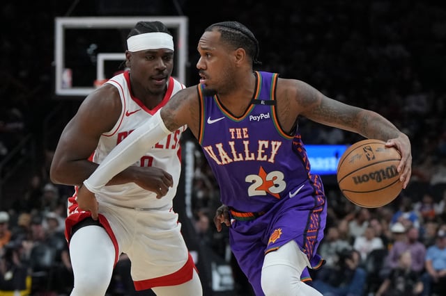 Mar 30, 2025; Phoenix, Arizona, USA; Phoenix Suns guard Monte Morris (23) drives on Houston Rockets forward Jae'Sean Tate (8) in the first half at Footprint Center. Mandatory Credit: Rick Scuteri-Imagn Images