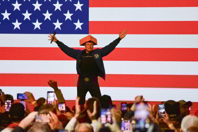 TOPSHOT - Elon Musk wears a Cheesehead hat as he speaks during a town hall in Green Bay, Wisconsin on March 30, 2025. An election to choose a new supreme court judge in the northern US state of Wisconsin wouldn't usually make much noise.
But when the world's richest man took an interest in the race, people began to notice, and protests on March 30 drew crowds.
Tech baron and political provocateur Elon Musk, a close ally of President Donald Trump, has poured money into the Tuesday election, hoping to secure a conservative win. (Photo by Robin LEGRAND / AFP) (Photo by ROBIN LEGRAND/AFP via Getty Images)