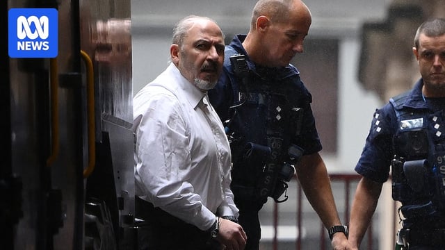 Tony Mokbel being lead into court from a prison van by an officer
