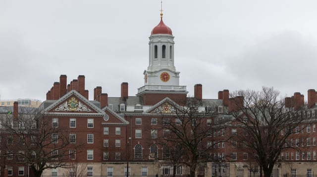 A person runs past Dunster House at Harvard University on March 17, 2025 in Cambridge, Massachusetts.