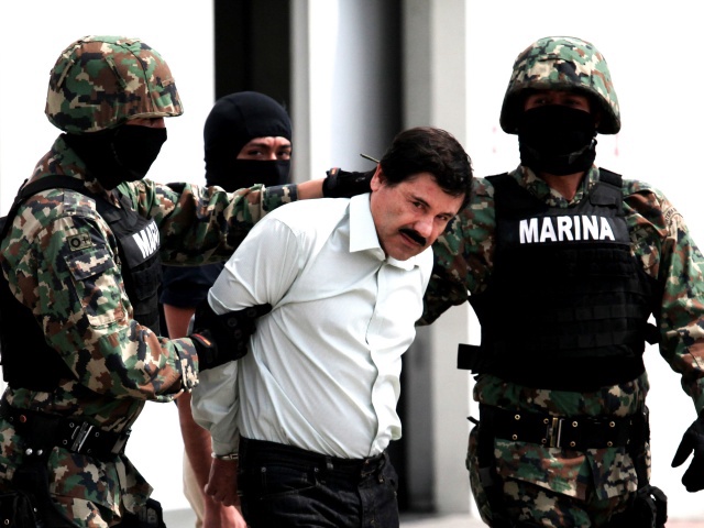 Mexican Navy soldiers escort Joaquin Guzman Loera (front), alias "El Chapo Guzman", leader of the Sinaloa Cartel, during his show up in front of the press, at the Mexican Navy hangar in Mexico City, capital of Mexico, on Feb. 22, 2014. Mexican President Enrique Pena Nieto on Saturday confirmed the capture of the world's most wanted drug lord, Joaquin Guzman Loera, known as El Chapo, in the Pacific resort of Mazatlan. (Photo by Jair Cabrera Torres/NurPhoto)