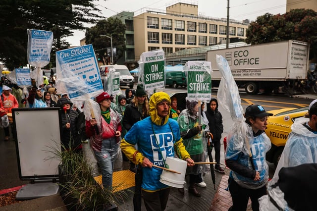 Workers from the UPTE and AFSCME unions walk around the UCSF Parnassus campus during a strike in San Francisco on Nov. 20. Another walkout is planned this week.