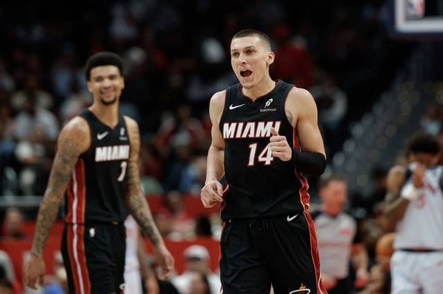 Miami Heat guard Tyler Herro (14) celebrates after his basket and a foul during the first half of an NBA basketball game against the Washington Wizards in Washington, Monday, March 31, 2025. (AP Photo/Terrance Williams)