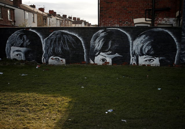 FILE PHOTO: A mural of the Beatles is seen painted on the end of a row of terraced houses in Liverpool, northern England February 18, 2015. Picture taken on February 18. REUTERS/Phil Noble/File Photo