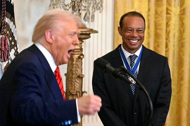 US President Donald Trump speaks alongside US golfer Tiger Woods, during a reception for Black History Month in the East Room of the White House on February 20, 2025, in Washington, DC.