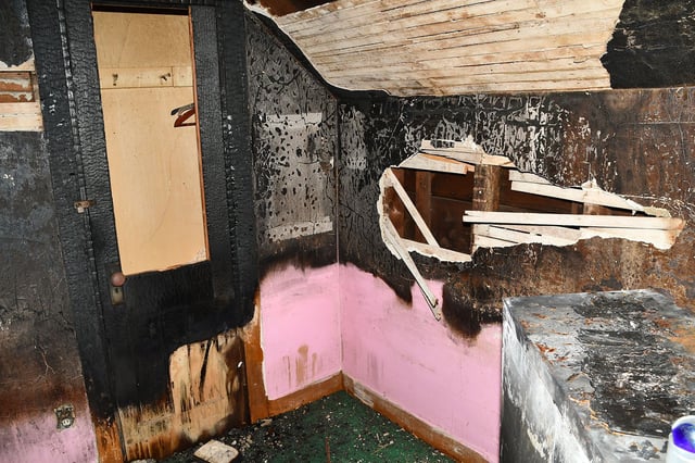 Police pictures show a charred room at the Waterbury home a man allegedly held captive by his stepmom started a fire with printer paper and hand sanitizer.