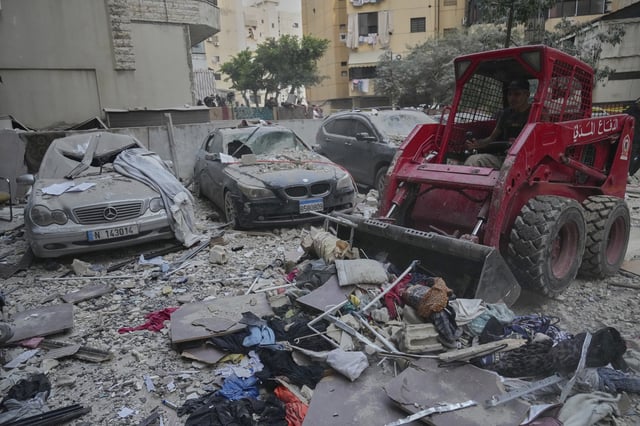 Civil defence workers clean the debris after an apartemnet building was hit by Israeli targeted strike in Dahiyeh, in the southern suburb of Beirut, Lebanon, early Tuesday, April 1, 2025.(AP Photo/Hussein Malla)