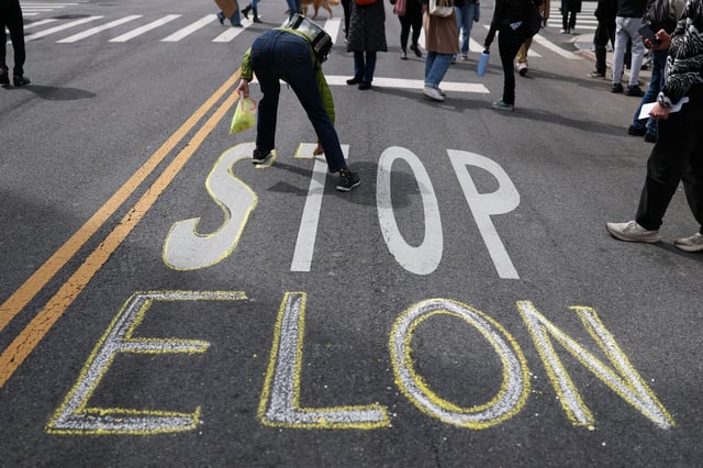 Protesters paint the street during a &#34;Tesla Takedown&#34; protest against CEO Elon Musk in New York on March 22.