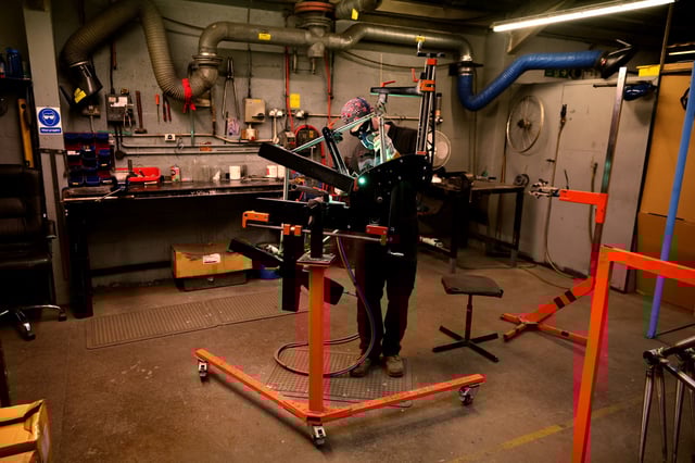 A worker assembles a new bike frame at the Pashley bicycle factory in Stratford-upon-Avon, Britain, June 30, 2022. REUTERS/Phil Noble/File photo