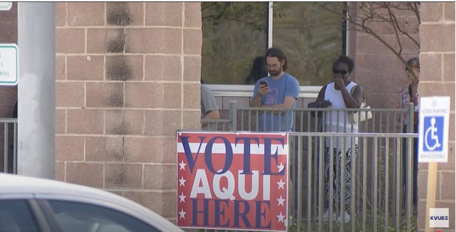 A sign directs AUTHOR NAME / WEBSITE  voters where vote.