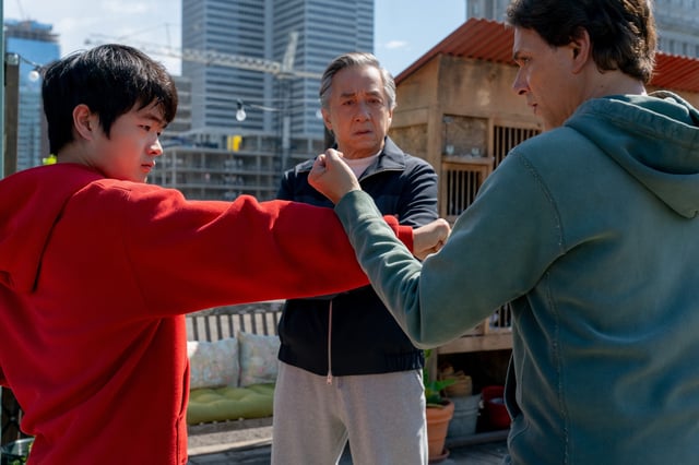 Before entering a big New York City martial arts tournament, Li Fong (Ben Wang, far left) learns from his kung fu shifu Mr. Han (Jackie Chan) and karate sensei Daniel LaRusso (Ralph Macchio) in "Karate Kid: Legends."