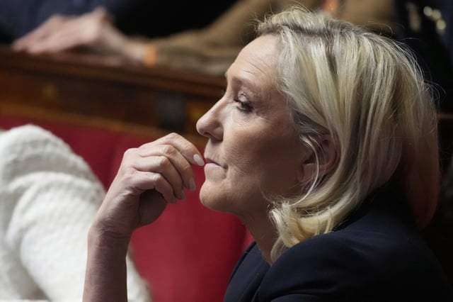 French far-right leader Marine Le Pen reacts at the National Assembly during a session Tuesday, April 1, 2025 in Paris. (AP Photo/Michel Euler)