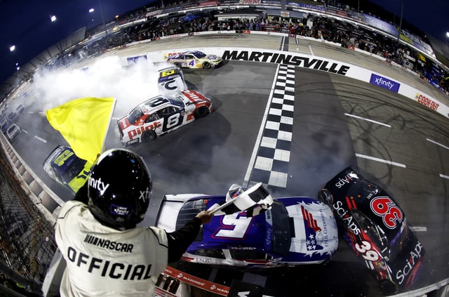Sammy Smith, driver of the #8 Pilot Chevrolet, Kris Wright, driver of the #5 First National Bank Corp Chevrolet, and Ryan Sieg, driver of the #39 Sci Aps Ford, spin after an on-track incident under caution to end the NASCAR Xfinity Series US Marine Corps 250 at Martinsville Speedway on March 29, 2025 in Martinsville, Virginia.
