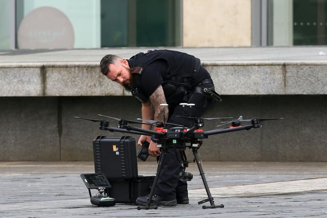 A Police officer uses a drone as he works outside the Arndale Centre shopping complex in Manchester, northwest England on October 11, 2019, following a series of stabbings. Police arrested a man on terror charges Friday after a mass stabbing at a shopping centre in Manchester, northwest England, that left five people injured. The man in his 40s was "lunging and attacking people" with a large knife in the Arndale shopping centre, Police Chief Russ Jackson said. The suspect was detained within five minutes and initially arrested for assault, before this was changed to an accusation of preparing and instigating an act of terrorism.