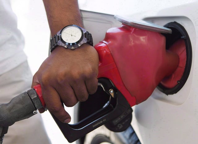 A person pumps fuel in Toronto after gasoline prices rose overnight on Wed., September 12, 2012.